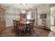 Inviting dining room with hardwood floors, a traditional chandelier, and natural light enhancing the warm atmosphere at 12542 W Parkwood Dr, Sun City West, AZ 85375