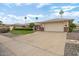 Charming single-story home featuring a well-manicured lawn and a two car garage at 12542 W Parkwood Dr, Sun City West, AZ 85375