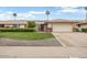 Charming single-story home featuring a well-manicured lawn and a two car garage at 12542 W Parkwood Dr, Sun City West, AZ 85375