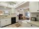 Functional kitchen with white cabinetry, tile flooring, black appliances, and an adjoining breakfast nook with a charming bay window at 12542 W Parkwood Dr, Sun City West, AZ 85375