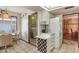 Efficient kitchen layout showcasing a wine rack, breakfast nook access, laundry room entrance, and adjacent dining area at 12542 W Parkwood Dr, Sun City West, AZ 85375