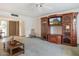 Living room featuring built-in entertainment center and carpeted flooring at 12542 W Parkwood Dr, Sun City West, AZ 85375