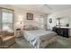 Sun-filled main bedroom with a sitting area, ceiling fan, and natural light at 12542 W Parkwood Dr, Sun City West, AZ 85375