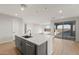 Modern kitchen island with white countertops, gray cabinets, stainless steel appliances, sink and faucet at 13551 W Calle De Baca --, Peoria, AZ 85383
