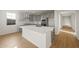 Stylish kitchen with a central island, quartz countertops, gray cabinets, stainless appliances, and tile backsplash at 13551 W Calle De Baca --, Peoria, AZ 85383
