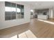 Open-concept living space with a view of the kitchen and lots of light from the large windows at 13551 W Calle De Baca --, Peoria, AZ 85383
