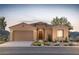 Charming single-story home with desert landscaping and a neutral color palette at sunset at 13768 W Calle De Baca --, Peoria, AZ 85383