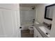 Modern bathroom with gray countertops, sleek black fixtures, and a tiled shower-tub combination at 1524 E Cortez St, Phoenix, AZ 85020
