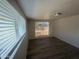 Bright bedroom featuring wood-look flooring and a window offering natural light at 1524 E Cortez St, Phoenix, AZ 85020