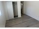 Clean bedroom with light gray wood-look flooring and closet space with a white sliding door at 1524 E Cortez St, Phoenix, AZ 85020