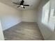 Bright bedroom featuring light gray wood-look flooring, ceiling fan, and ample natural light at 1524 E Cortez St, Phoenix, AZ 85020