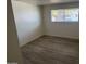 Cozy bedroom with wood-look flooring, clean white walls, and a window offering plenty of light at 1524 E Cortez St, Phoenix, AZ 85020