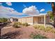 Home exterior featuring desert landscaping, complemented by an enclosed patio and a serene backyard at 155 E Rodeo Rd # 64, Casa Grande, AZ 85122