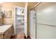 Open bathroom with shower and vanity; view to a bedroom with ceiling fan at 155 E Rodeo Rd # 64, Casa Grande, AZ 85122