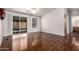 Bright bedroom featuring sliding glass doors, neutral walls, wood-look floors, and an en-suite bathroom at 155 E Rodeo Rd # 64, Casa Grande, AZ 85122