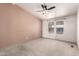 Spacious bedroom with neutral carpet, accent wall, ceiling fan and natural light at 155 E Rodeo Rd # 64, Casa Grande, AZ 85122