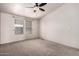 Bedroom featuring neutral carpet, ample natural light, and a ceiling fan at 155 E Rodeo Rd # 64, Casa Grande, AZ 85122