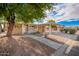 Inviting home exterior featuring covered parking, desert landscaping, and a charming front porch at 155 E Rodeo Rd # 64, Casa Grande, AZ 85122