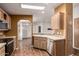 Well-lit kitchen featuring wood cabinets, stainless steel appliances, and an open layout to the living area at 155 E Rodeo Rd # 64, Casa Grande, AZ 85122