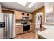 Well-lit kitchen with stainless steel appliances, wood cabinets, and wood flooring at 155 E Rodeo Rd # 64, Casa Grande, AZ 85122