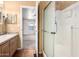 Open bathroom with shower and vanity; view to a bedroom with ceiling fan at 155 E Rodeo Rd # 64, Casa Grande, AZ 85122