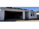 Exterior of a new home showing open garage for two cars. Personalize this blank slate at 15788 W Beryl Ave, Waddell, AZ 85355