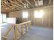 Unfinished room with exposed wooden beams and open sliding glass doors ready for customization at 15788 W Beryl Ave, Waddell, AZ 85355