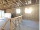 Unfinished living room area with two windows and sliding glass door at 15788 W Beryl Ave, Waddell, AZ 85355