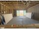 Unfinished living room framing with sliding glass door and view of the backyard at 15788 W Beryl Ave, Waddell, AZ 85355