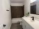 Updated bathroom featuring a shower-tub combination and a modern vanity with a white countertop at 1802 W Frier Dr, Phoenix, AZ 85021