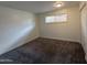 Neutral bedroom featuring plush carpeting, a window and a closet with sliding doors at 1802 W Frier Dr, Phoenix, AZ 85021