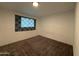 Neutral bedroom featuring plush carpeting and a window with decorative dark fabric curtains at 1802 W Frier Dr, Phoenix, AZ 85021
