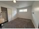 Well-lit bedroom featuring a window, closet with sliding doors, and neutral-colored carpeting at 1802 W Frier Dr, Phoenix, AZ 85021