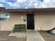 Secured front entrance with black security door and outdoor seating bench at 1802 W Frier Dr, Phoenix, AZ 85021