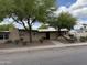 Single-story home with mature trees and a desert-landscaped front yard at 1802 W Frier Dr, Phoenix, AZ 85021