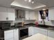 Well-lit kitchen with stainless steel appliances, black hardware, and bright countertops at 1802 W Frier Dr, Phoenix, AZ 85021
