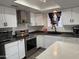 Bright kitchen boasts stainless steel appliances, black hardware, and bright countertops at 1802 W Frier Dr, Phoenix, AZ 85021