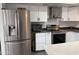 Spacious kitchen featuring stainless steel refrigerator and ample cabinet space at 1802 W Frier Dr, Phoenix, AZ 85021