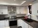 Bright kitchen features stainless steel appliances, white cabinets, and modern fixtures at 1802 W Frier Dr, Phoenix, AZ 85021