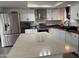 Open kitchen features stainless steel appliances and island with bright countertop at 1802 W Frier Dr, Phoenix, AZ 85021