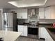 Modern kitchen boasts stainless steel appliances and sleek white cabinetry at 1802 W Frier Dr, Phoenix, AZ 85021