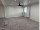Open living room with carpeting and a large window with white drapes at 1802 W Frier Dr, Phoenix, AZ 85021