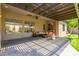 Backyard featuring brick flooring, comfortable seating arrangements, artificial grass, and a covered pergola at 2011 W Calle De Las Estrella --, Phoenix, AZ 85085
