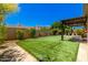 Spacious backyard with artificial grass, mature landscaping, and a covered patio area with hammock at 2011 W Calle De Las Estrella --, Phoenix, AZ 85085