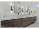 Bathroom featuring a dual sink vanity with granite counters and modern lighting at 2011 W Calle De Las Estrella --, Phoenix, AZ 85085