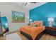 Bedroom with a teal accent wall and plush bedding, and natural light from the window at 2011 W Calle De Las Estrella --, Phoenix, AZ 85085