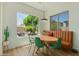 Bright dining area with green chairs, wood floors, and a large window viewing the backyard at 2011 W Calle De Las Estrella --, Phoenix, AZ 85085