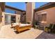 Spacious outdoor patio featuring brick flooring, a built-in fireplace and comfortable seating arrangements at 2011 W Calle De Las Estrella --, Phoenix, AZ 85085