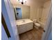 Well-lit bathroom with a vanity, mirror, shower, and toilet, featuring tile flooring at 20275 N 81St Ln, Peoria, AZ 85382