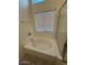 Bathroom featuring a soaking tub, a glass shower, and a window at 20275 N 81St Ln, Peoria, AZ 85382